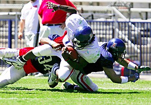 Running back Chris Henry is pulled down by safety Brandon Tatum  during the second football scrimmage of the spring practice season, Saturday April 8, 2006. (photo by chris coduto/arizona daily wildcat)