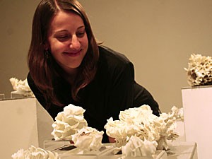 Jessica Drenk, a fine arts graduate student, shows off her sculptures yesterday afternoon in the Joseph Gross Gallery. Her works are made from dipping q-tips, cotton balls, toilet paper, napkins and coffee filters into porcelain.