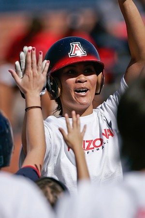 Former Arizona softball player Lovie Jung celebrates after hitting a first-inning home run during the softball alumnae game on Saturday afternoon at Hillenbrand Stadium. The alumnae team beat this years Wildcat team 4-1 in five innings.