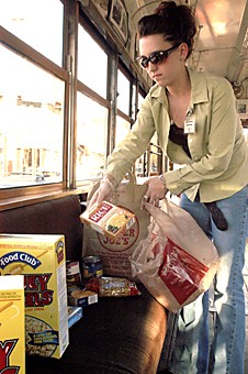 Mallory Loring / Arizona Daily Wildcat

This is Stephanie Porter, Youth Board Member of the Community Food Bank (business freshman), putting donated food on the trolly