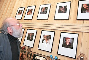Harvey Brooks, the music consultant at the 17th Street Market, looks at photographs of prominent music artists he knows that adorn the wall in the music section of the market. Along with the food, the market also stages small musical performances every Saturday.