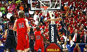 UA point guard Jerryd Bayless (0) flies through the air for a dunk during the Blue teams 76-63 win over the Red team in the annual Red-Blue Game last night in McKale Center. The freshman led his classmates on the team with 26 points, including three shots from behind the arc.  