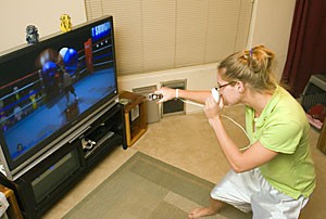 UA grad, Jennifer Barclay, knocks-out the competition in a round of Wii Sports boxing. The Wii video game system has had mass appeal for both genders and is still hard to find in many stores.