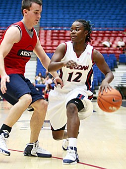 Arizona womens basketball senior guard Ashley Whisonant looks for an open teammate as she is defended by a member of the practice squad in the annual Red & Blue Game yesterday in McKale Center, which the womens team lost, 73-41, to its mens practice squad. Whisonant led the women with nine points to go with four rebounds and four assists.