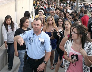 Hundreds of concertgoers anxiously wait in line to enter McKale Center for the Kanye West show last Thursday night. Ticket sales exceeded expectations, making about $450,000.