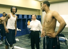 Members of the UA basketball team share a moment in their locker room after the loss to Louisville. Despite the loss, coaches and players said this season could be considered a success because of the squads run to the Sweet 16.  