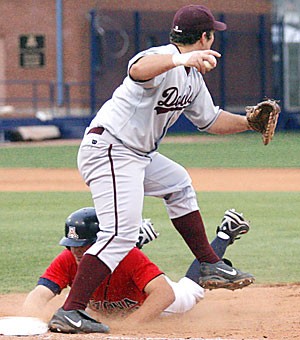 UA outfielder Brad Glenn slides into ASU first baseman Brett Wallace in Arizonas 22-8 loss to the Sun Devils last night at Sancet Stadium. Glenn, who went 2-for-4 with a home run, was out in a rare triple play.