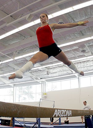 Junior Bree Workman works on her no-arm balance beam routine during practice at the Mary Roby Gymnastics Training Center. Workman has overcome two major medical problems to become a main contributor for the Gymcats.