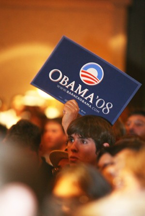 A supporter for President-elect Barack Obama holds up a campaign sign Tuesday night at the Democratic Partys rally at the Marriott on North University Boulevard.