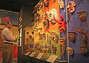 Third-year volunteer museum interpreter Phil Davis admires the Arizona State Museums collection of traditional and nontraditional masks of the Southwest. The museum, which has more than 10,000 historical artifacts, may expand downtown as part of the Rio Nuevo project in early 2009. 