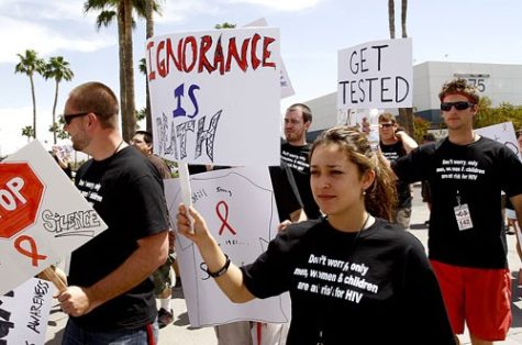 Shaylee Koontz of Los Angeles joins about 150 patrons of this year's Coachella Valley Music & Arts Festival in an AIDS-awareness march in Tucson yesterday. The two-and-a-half mile route ran along North Campbell Avenue on the eastern border of the UA before ending in Himmel Park.