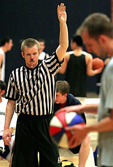Basketball intramurals referee Steve Stout works a game at Bear Down Gym. Stout makes $5.50 per game but said he does it for the free entertainment.