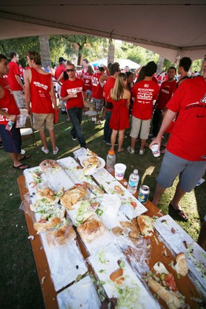 UA students ravage the tables of free sub sandwiches during the Homecoming celebration before kickoff at the UA vs. USC football game on Oct. 25.