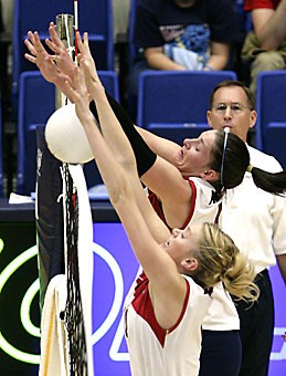 Middle blocker Jacy Norton, front, and opposite hitter Randy Goodenough, back, try to get the ball over the net in Fridays win over Washington State in McKale Center. The win stopped a seven-game losing streak.