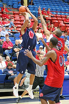 Forward Marcus Williams shoots over forward Jordan Hill, bottom right, and guard J.P. Prince, top, during an Oct. 21 scrimmage. Williams will return to the lineup tonight in Arizonas exhibition game against Victoria after missing over a week of practice.