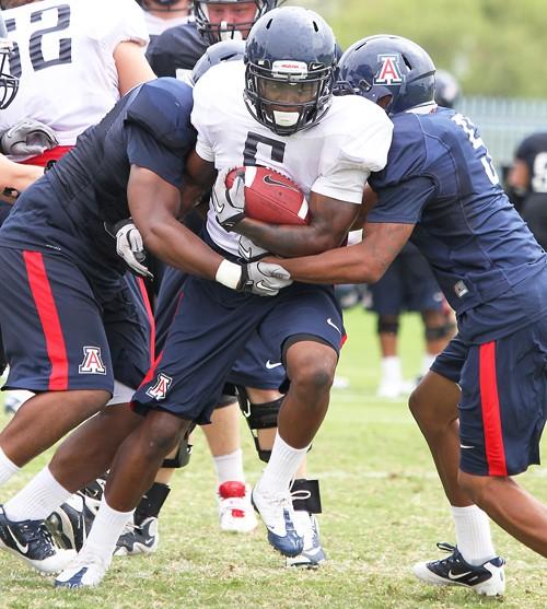The University of Arizona football team takes part in morning practice Tuesday, Aug. 17, 2010, at the Rincon Vista Sports Complex in Tucson, Ariz. The Wildcats look to reach a bowl game for the third season in a row with quarterback Nick Foles at the helm.
(Photograph by Mike Christy)