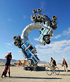 Burning Man festival participants enjoys the playa near an art installation in the Black Rock Desert in Gerlach, Nev., on Friday morning.