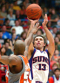 Phoenix point guard Steve Nash shoots over teammate Brian Skinner in the Suns intrasquad scrimmage in McKale Center on Saturday night. It marks the second time in three years the Suns have called Tucson their home for the preseason.