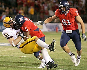 Arizona cornerback Antoine Cason tackles former ASU tight end Zach Miller in last years Territorial Cup game at Arizona Stadium, which ASU won 28-14. Cason has been responding to Sun Devil quarterback Rudy Carpenters preseason trash talk and expects to do more yapping on the field in this Saturdays Cup game in Tempe.