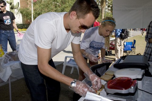 Sam Shumaker / Arizona Daily Wildcat

Physical education senior Brian MacArthur, left, and undeclared freshman Jen Bergman, both UA cross country runners in the Feel Good Club, cook up grilled cheese sandwiches on the mall yesterday afternoon for money donations. For every dollar donated, a $1.20 goes to the Hunger Project, an organization that feeds starving communities across the world.