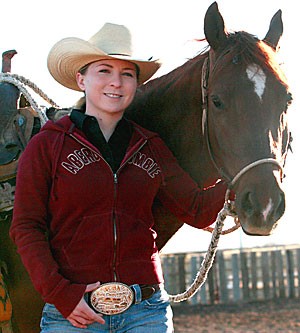 Heather Raftery, a senior majoring in journalism and anthropology, stands with her horse, Sbydwr, at her familys barn just south of Green Valley. Two weeks ago she and Sbydwr won a world champion belt buckle at the National Cutting Horse Association World Finals in Amarillo, Texas.