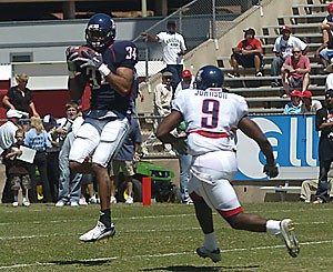 UA safety Brandon Tatum intercepts a pass from quarterback Willie Tuitama in Saturdays annual Spring Game at Arizona Stadium. After throwing interceptions in his first two drives, Tuitama recovered to throw for 292 yards and two touchdowns in the 93-play scrimmage.