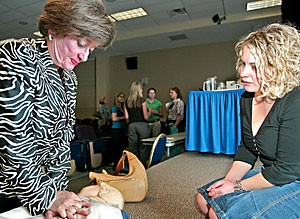 Paula Baltes, widow of Paul Baltes, practices the new method of consistent compression CPR. The Heart Health Lecture was held in honor of her husband, who died unexpectedly from heart failure in December 2003.