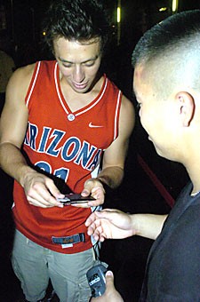 Finance senior Scott Schindler, left, has his CatCard swiped at the Zona Zoo entrance prior to Arizonas loss to New Mexico on Saturday. Last weeks taser incident and crowded lines prompted ASUA and Arizona Athletics officials to have more staff to check in Zona Zoo members over the weekend.