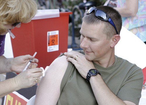 Timothy Galaz / Arizona Daily Wildcat
Todd Craig, 39, Systems Analyst for Student Affairs, gets a flu shot in front of the PAs Building last semester, Tuesday, September 29, when for a week Campus Health Services offered the vaccine for free at locations all over campus.