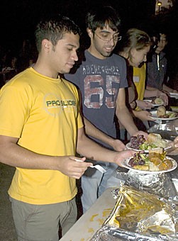 Mechanical engineering junior Kamal Alhamidi and mechanical engineering sophomore Saber Al-alshaikh partake in the festivities that ended the Muslim fast. Hundreds of people showed up for the breaking of the fast last night at the Highland Commons.