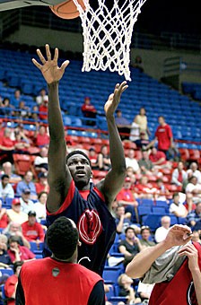 Sophomore forward Mohamed Tangara goes up for a shot over Jawann McClellan in last Saturdays scrimmage in McKale Center. Tangara made the long journey from Africa six years ago, and finally got a chance to visit his homeland of Mali again this summer.
