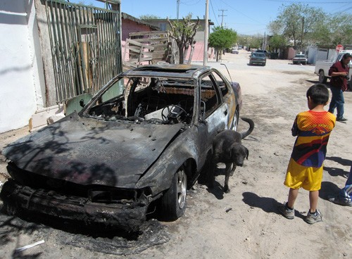 A Honda Accord is nothing but a charred wreck after street gangs set it on fire in Ciudad Juarez April 8, 2010. The owner allegedly didn't pay up on an extortion demand. (Tim Johnson/MCT)
