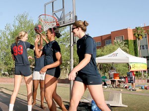 From left, Wildcat volleyball players Brooke Buringrud, Tiffany Owens, Whitney Dosty and Randy Goodenough shoot hoops on the UA Mall yesterday as part of the 48-Hour Practice to help raise money to build clean water wells in Africa. The practice, organized in part by former UA track and field athlete Marquita Taylor, runs through tomorrow at 3 p.m. 