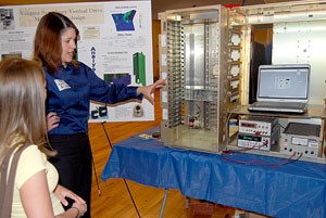 Sara Brickley, right, a mechanical engineering senior, explains her capstone project, the Ventana Symphony Vertical Drive Mechanism Redesign, to Lauren Steel, a biology senior, at the Engineering Senior Capstone Fair yesterday in the Student Union Memorial Centers Grand Ballroom.