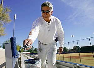 Greg Granados, who works in the facilities management paint shop, paints the bleachers at Sancet Stadium. Two sections of bleachers have been removed to add grass seating as part of a renovation project.