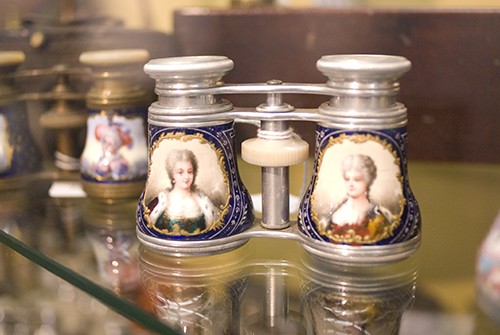 A pair of French opera glasses dating from the late 1800s on display at the new optics museum in the college of optical sciences building.  According to John Greivenkamp, professor of optical sciences and owner of the collection on display, the glasses are made of aluminum ? which was rare at the time ? and, along with the hand-painted portraits in enamel, indicate that they were owned by a wealthy family.