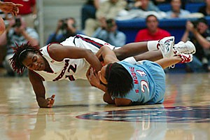Arizonas Ashley Whisonant wrestles for the ball with Louisiana Techs Shan Moore during the Wildcats 74-59 win over the Lady Techsters last night. Whisonant finished with a season-high 22 points.