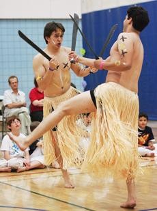 From the left, David Dick and Cristobal Barajas perform a Capoeria dance at the Capoeira Mandinga Tucson 