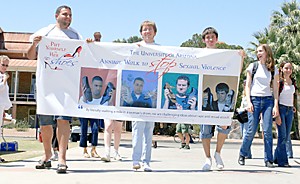 Ari Lerner/ Arizona Daily Wildcat
Ahmed Fakhouri, undecided sophomore, Matt Hall, mathematics sophomore and Alex Navas, music education freshman walk a mile on the UA mall yesterday wearing womens shoes. The annual walk is to raise awareness about violence against women.
