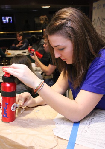 Lisa Beth Earle / Arizona Daily Wildcat

Alana Sorge, an education freshman, decorates a reusable water bottle during a Recyclemania event at Kaibab-Huachuca on Wednesday, Jan. 27. Sorge is on the dorms hall council as an eco representative and says that programs like this is what she loves. 