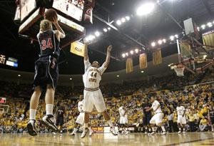 Arizona sophomore forward Chase Budinger (34) attempts a 3-pointer over ASUs Jerren Shipp in the Sun Devils 64-59 overtime win in Tempe Jan. 9. Budinger is expected to play point guard in relief of an injured Nic Wise in the teams rematch Sunday.