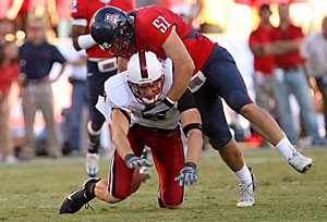 UA linebacker Spencer Larsen hits Stanford wide receiver Evan Moore during the Wildcats 21-20 loss Saturday at Arizona Stadium. Larsen and the rest of the football team will face another flighty Washington quarterback tomorrow at noon in Seattle. 