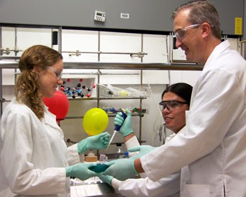 UA Associate Professor Mark Marty Pagel, far right, with chemical engineering student Michelle Benson, left, and University of Arizona Cancer Center student Tony Ward. Pagels MRI method produces an image that maps the acid content in tissues, which enables doctors to monitor the effectiveness of personalized treatments such as baking soda on tumors and normal tissue, and could even predict the effectiveness of chemotherapies before the patient starts the medication. UA Biomedical Engineering photo.