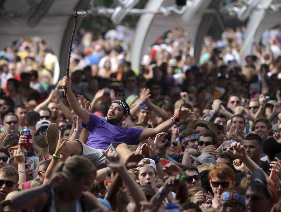 A crowd surfing fan records the moment with a camera attached to a stick during a set by Perry Farrell at Lollapooza in Chicago, Illinois, Saturday, August 6, 2011. (Chris Sweda/Chicago Tribune/MCT) 