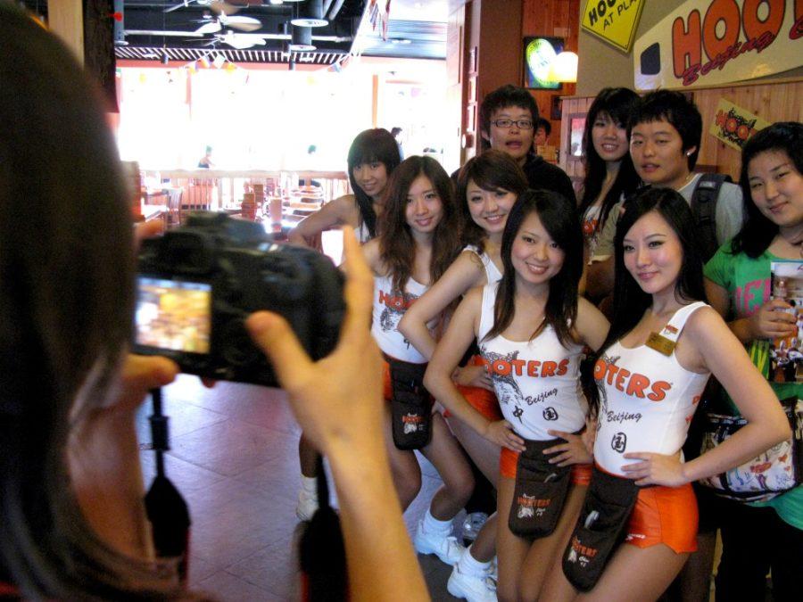 The+Hooters+Girls+pose+for+a+picture+with+customers+at+Beijings+Hooters+in+China.+The+chain+restaurant%2C+known+for+their+chicken+wings+and+attractive+waitresses%2C+came+to+China+four+years+ago%2C+and+opened+a+branch+in+Beijing+last+September.+%28Kevin+Pang%2FChicago+Tribune%2FMCT%29