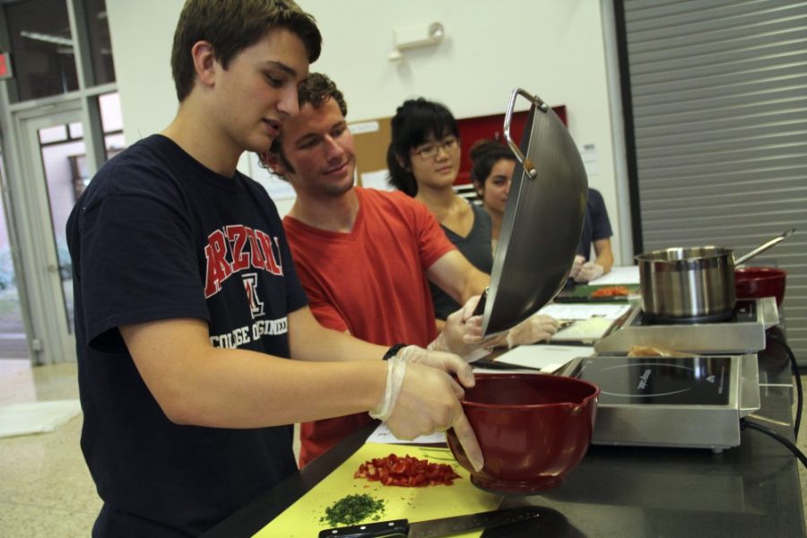 Noelle R. Haro-Gomez/ Arizona Daily Wildcat

UA students, Jeffrey Bragg and Bryce Schuler, make chicken and shrimp paella at the Rec Center on Tuesday, Sept. 25, 2012.