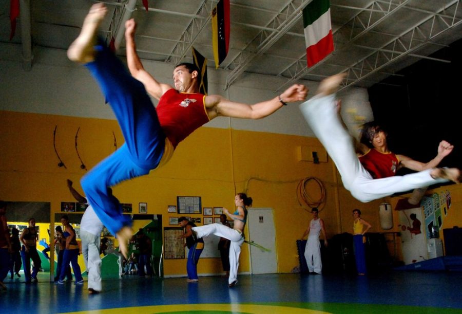 Roberto Armien, left, and Brian Schmidt practice during a Capoeira workout, May 9, 2006, in Orlando, Florida. Capoeira, a dance, a fight, a form of self-defense - and above all a fun way to keep fit, is the latest fitness craze to sweep the country. (Red Huber/Orlando Sentinel/KRT)