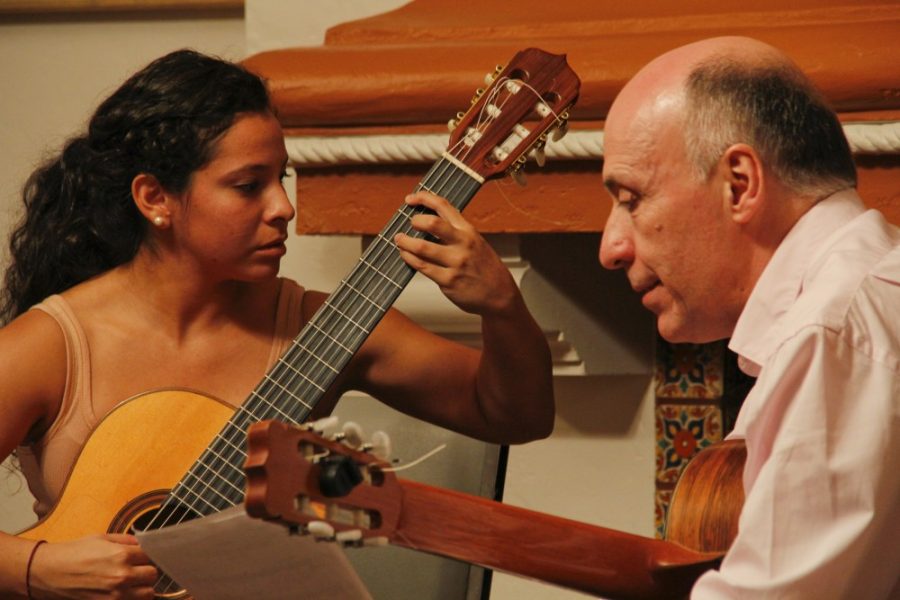 Noelle R. Haro-Gomez /  Arizona Daily Wildcat

From the left, Kathy Acosta plays guitar while Carlos Bonell gives her a critique. Acosta is a junior at the UA studying guitar performance. 
