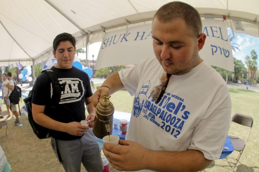 Robert Alcaraz / Arizona Daily Wildcat

Ben Berger, a sophomore, pours tea for friend Shahar Ben-Yelshaua during Israelpalooza on the UA mall on Wednesday, Oct. 17, 2012.