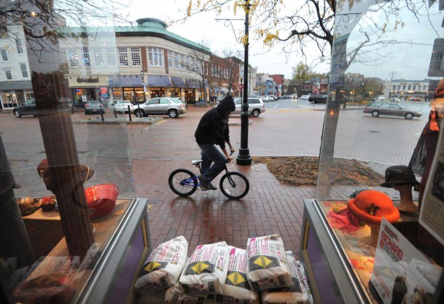 A bicyclist rides by Hats in the Belfry on Main Street in Annapolis, Maryland, Sunday, October 28, 2012. The store has already stacked sandbags outside one of their doors. Annapolis merchants get ready for Hurricane Sandy. (Algerina Perna/Baltimore Sun/MCT)